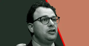 A man with glasses speaking, set against a split dark green and brown background with a red diagonal line.