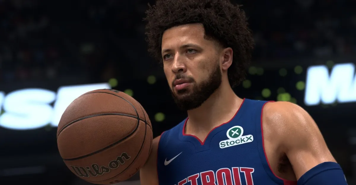 Basketball player in a blue Detroit jersey holds a Wilson basketball, StockX logo visible, blurred background.
