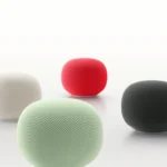Four spherical smart speakers in white, red, mint green, and black on a white background.