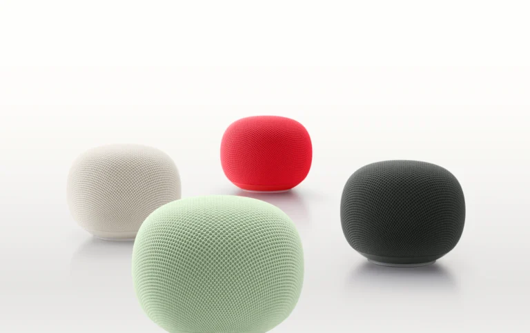 Four spherical smart speakers in white, red, mint green, and black on a white background.