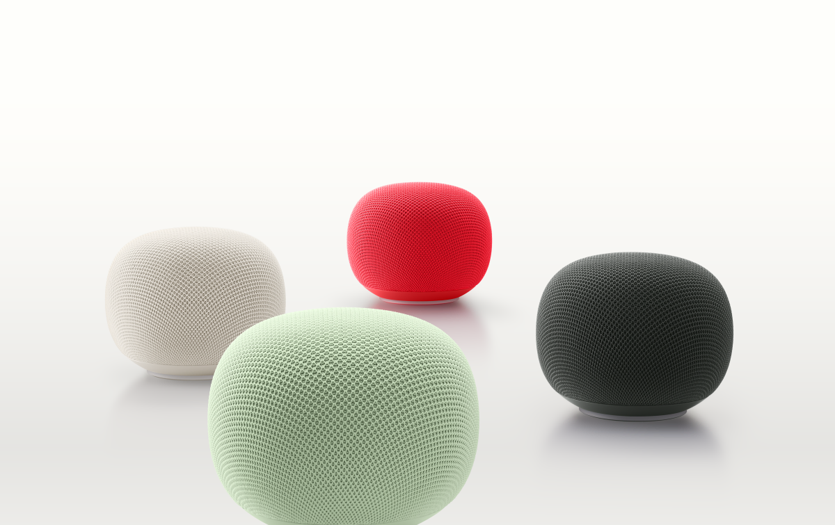 Four spherical smart speakers in white, red, mint green, and black on a white background.