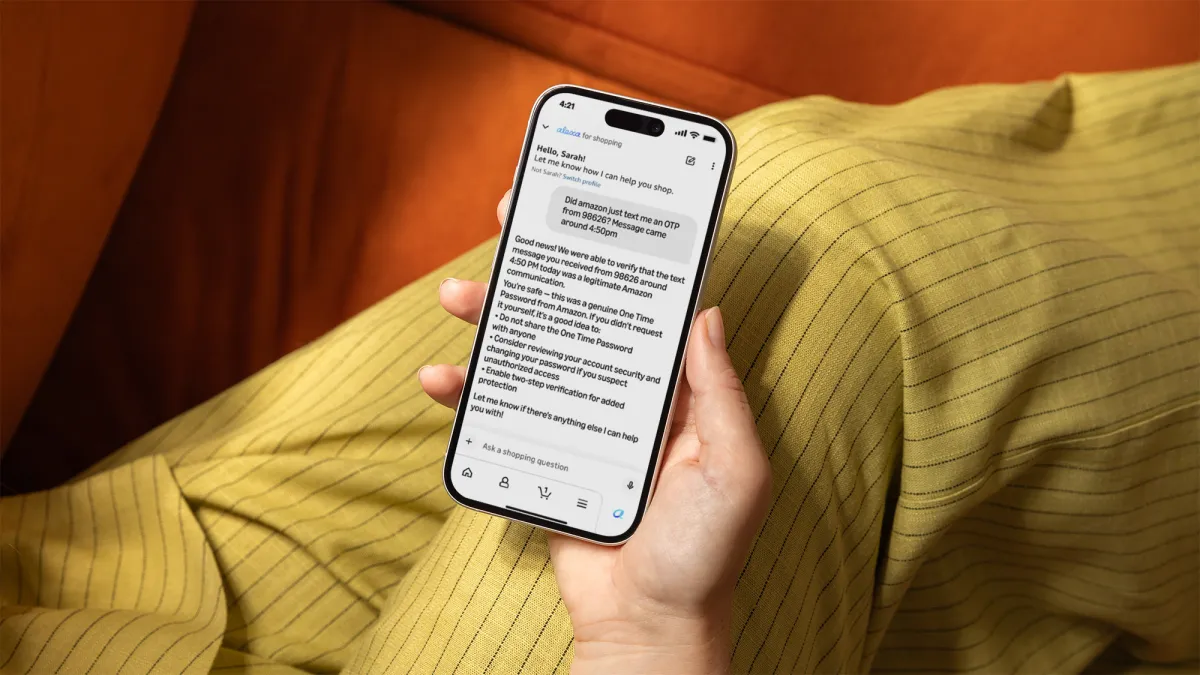Person holding a smartphone displaying a message from Alexa for Shopping about verifying a suspicious OTP message.