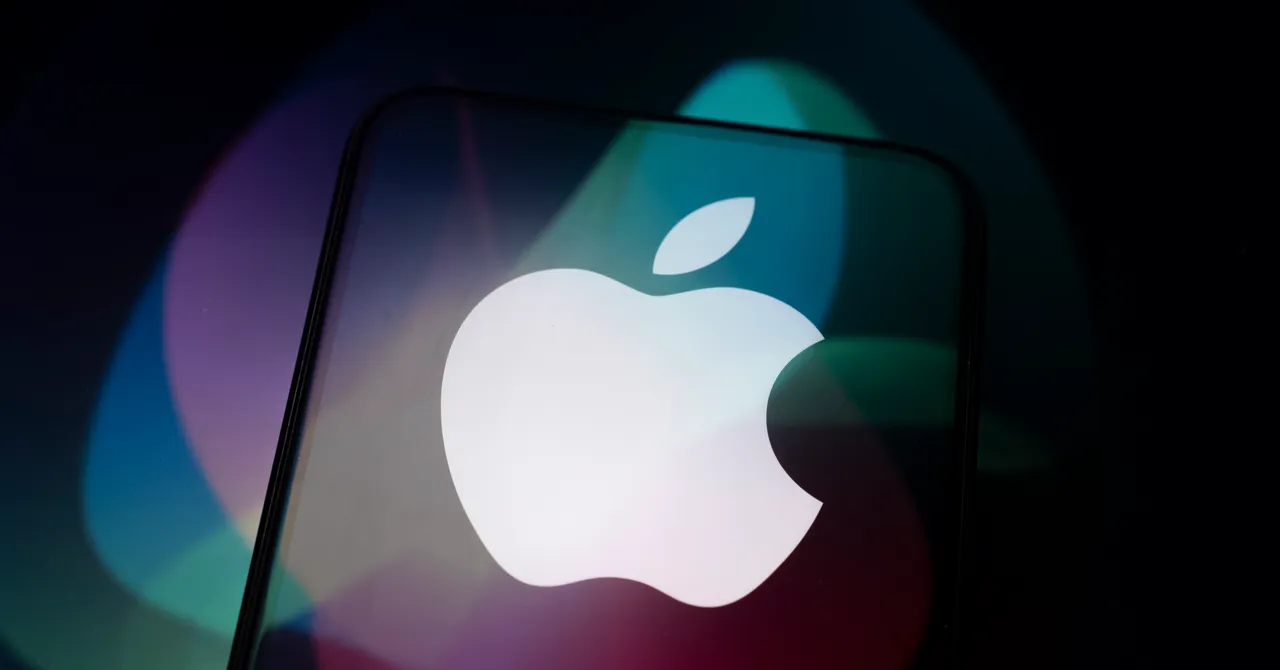 Apple logo on a smartphone screen with colorful blurred lights in the background.