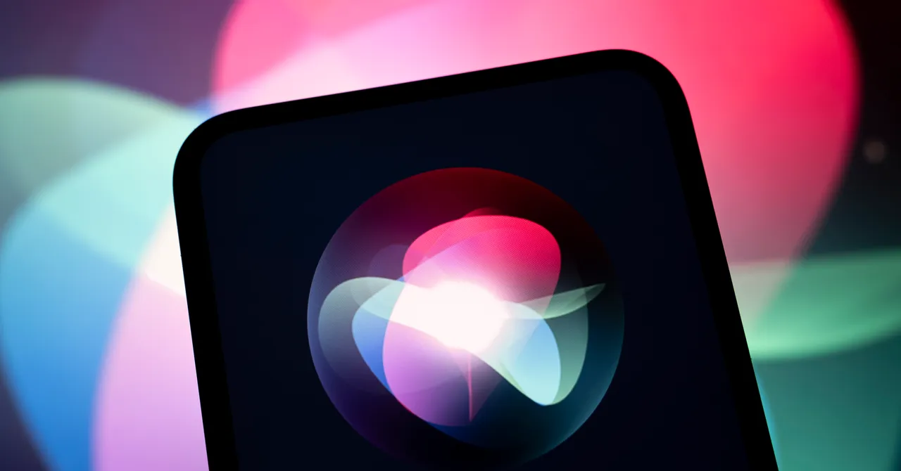 Smartphone screen displaying a colorful Siri logo, set against a blurred pink and blue background.