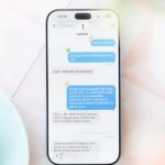 Smartphone displaying a chat with Instinct AI about returning IKEA items, set on a light table next to a latte.