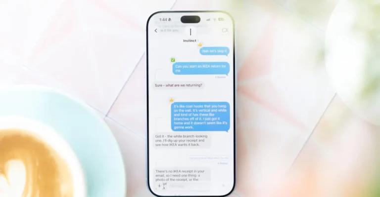 Smartphone displaying a chat with Instinct AI about returning IKEA items, set on a light table next to a latte.