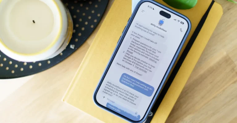 Smartphone on a book displaying a chat with an AI assistant named "dotty mcdotface" discussing task management.