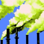 Several smokestacks emitting thick yellow-green smoke against a clear blue sky.