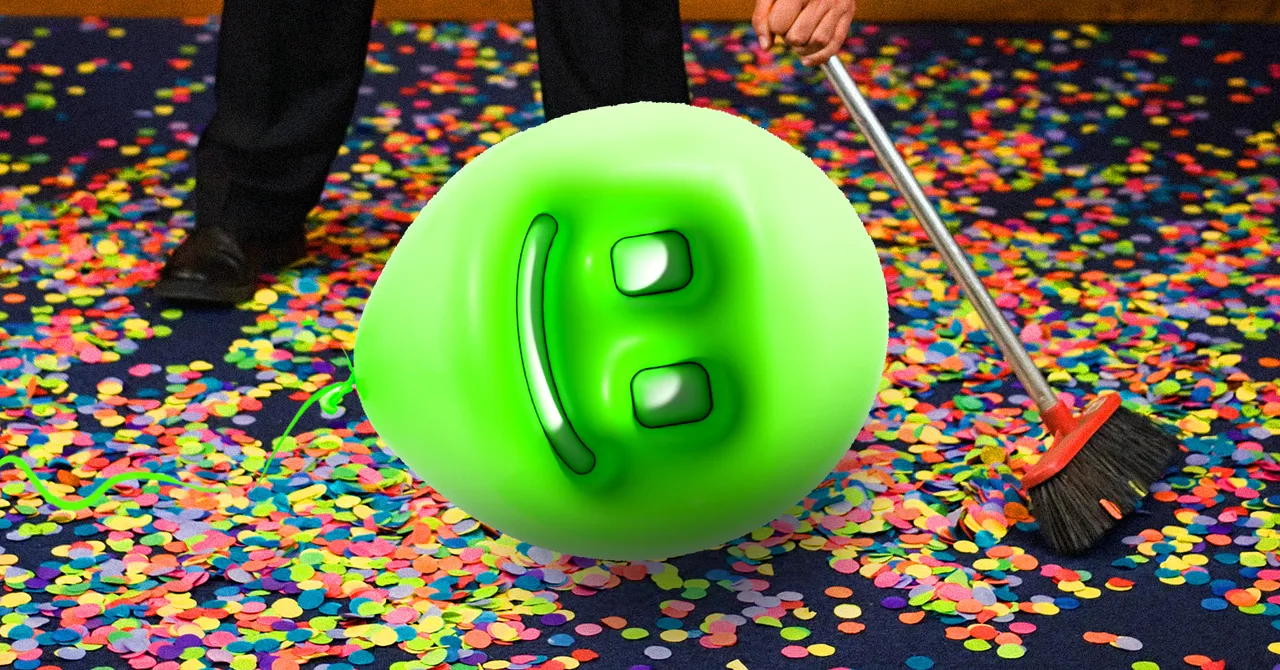 Green smiley balloon on confetti-covered floor, person sweeping with a broom.