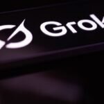 Grok logo in white on a dark background, featuring a stylized circular design.