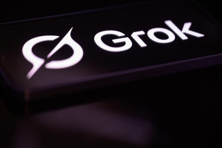 Grok logo in white on a dark background, featuring a stylized circular design.