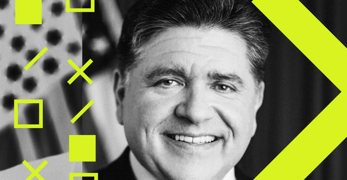 Smiling man in a suit with geometric patterns and bright yellow accents, black and white photo.