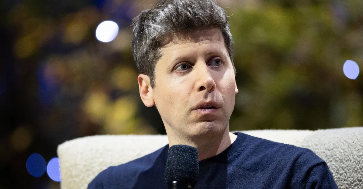 Person holding a microphone, looking to the side, blurred background with lights.