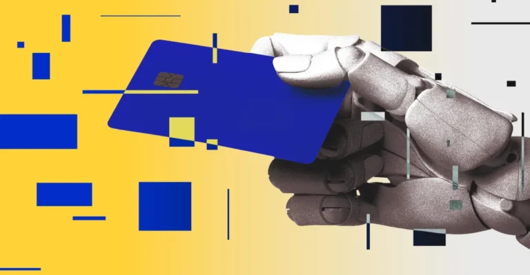 Robotic hand holding a blue credit card against a yellow background with scattered geometric shapes.