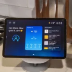 Echo Show displaying weather, time, and recently played media in a modern kitchen setting.