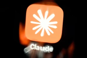 Orange app icon with a white starburst design, labeled "Claude" below, on a dark background.