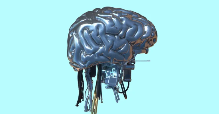 Metallic brain sculpture with cables and electronic components on a light blue background