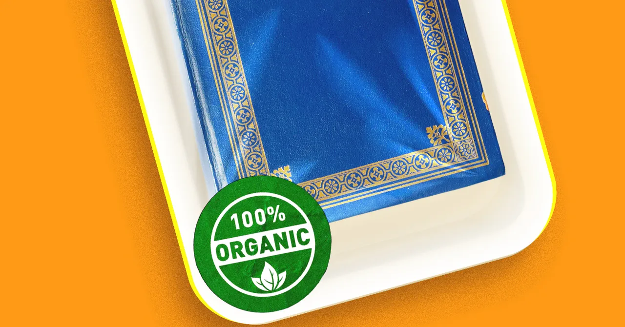 Blue book with gold decorative border on a white tray, green "100% Organic" seal in the corner, orange background.
