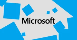 Microsoft logo centered on a gray background with scattered blue squares.