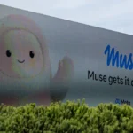 Billboard with cartoon character and text "Muse gets it done" above trees, featuring Meta logo.