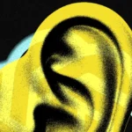 Stylized yellow ear with a blue cloud outline on a black background