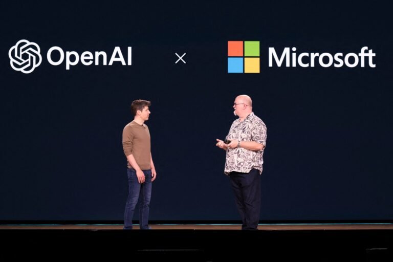 Two men on stage discussing under OpenAI and Microsoft logos on a dark background.