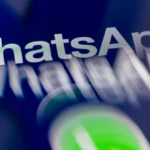 Blurry WhatsApp logo with green icon on a dark background, text appears duplicated and distorted.