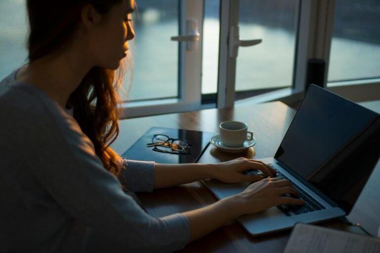 Women 40-plus AI dinner club meeting around a table with laptops